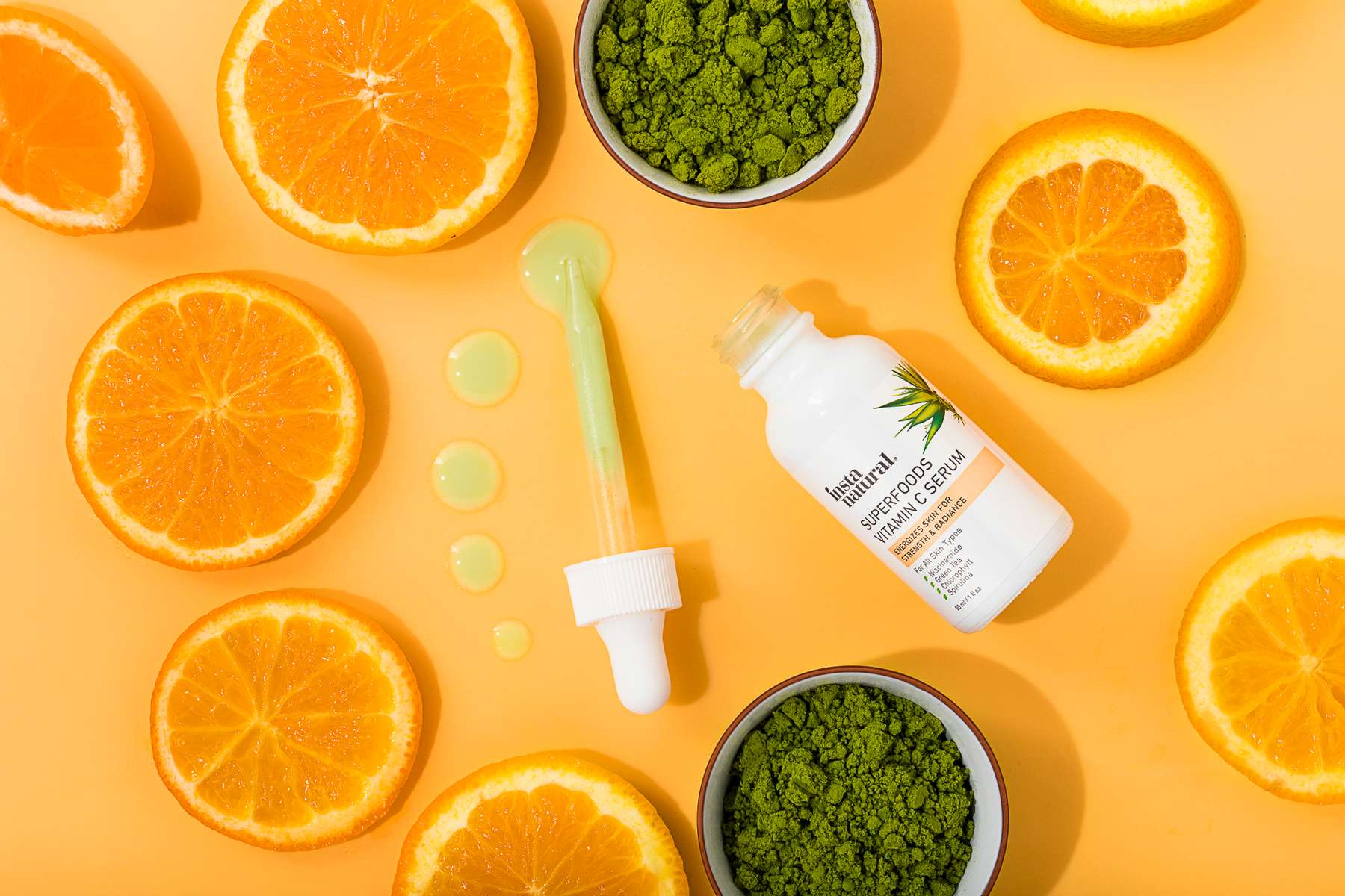 Oranges and spirulina on an orange background for Instanatural Skin Care, by JAM Creative.