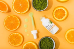 Oranges and spirulina on an orange background for Instanatural Skin Care, by JAM Creative.