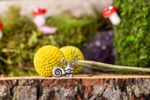 A happy pewter snail sit's in front of flowers Advertising photo for the Danforth Pewter catalog.