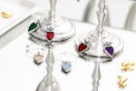 Colorful enamel and pewter heart shaped wine markers adorn two pewter wine goblets for the danforth pewter catalog.