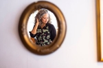 Apparel photography for April Cornell. A womens in an apron is reflected in a wall mirror.