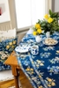 A blue table cloth with matching pillow is set for breakfast in this catalog shot for April Cornell.