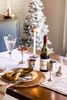 Polished pewter dishware adorn a festive christmas table for this Danforth Pewter catalog image.