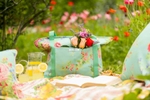 A blue flower patterned cooler in a picnic scene, photographed for the home and apparel company, April Cornell.
