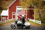 Jeffrey Schnapp poses for a portrait on his California Motto Guzzi motorcycle in front of a barn in Woodstock, Vermont.