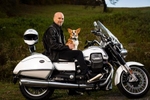 Jeffrey Schnapp and his pet Corgi sit for a portrait atop his California model Moto Guzzi motorcycle at his home in Woodstock, Vermont.