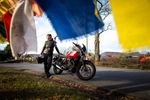 Melissa Holbrook Pierson poses for a portrait with her Moto Guzzi motorcycle in the Catskill mountains in New York.
