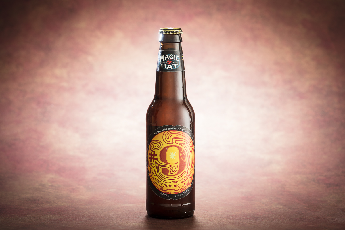Magic Hat Brewing Company beer Number 9 Not Quite Pale Ale bottle on pale pink background.  By commercial photographers at JAM Creative.