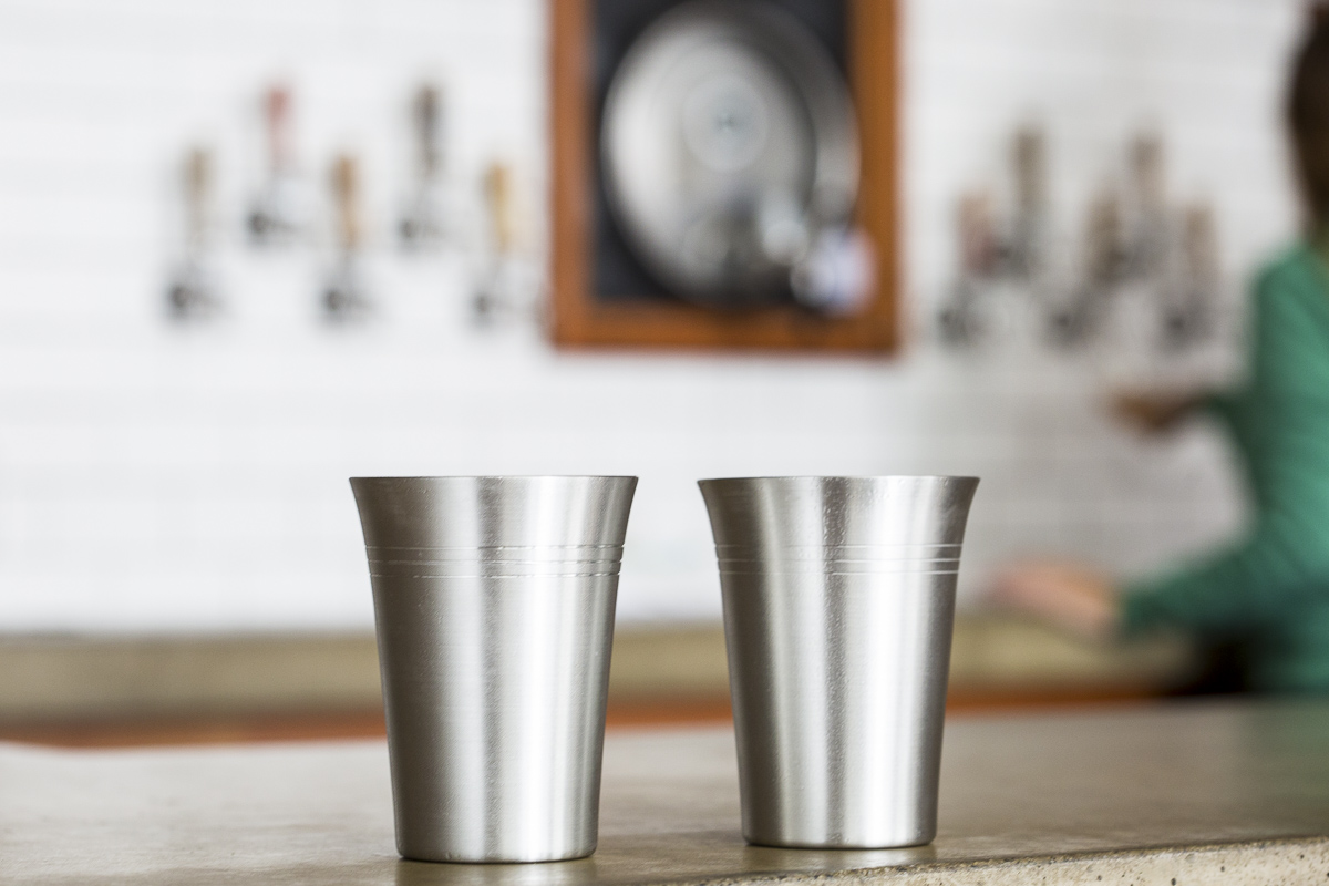 Pewter pint glasses being filled at Zero Gravity Brewery. Cups by Danforth Pewter photographed by JAM Creative
