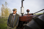 A fermer by his tractor during a guided tour with Country Walkers. by JAM Creative