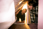 A contracter performs a home energy efficiency audit for a couple in Richmond, Vermont. by Reciprocity Studio photographers for Efficiency Vermont