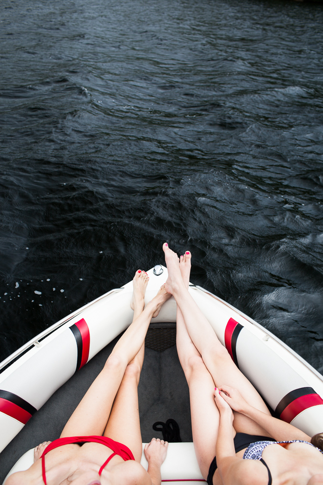 Two young women boating, Kezar Lake, maine. by Vermont photographers at Reciprocity Studio, Burlington