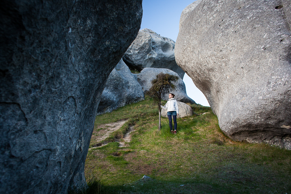 Young woman hiking through boulders in Arthur's Pass, New Zealand. by Vermont photographers at Reciprocity Studio, Burlington