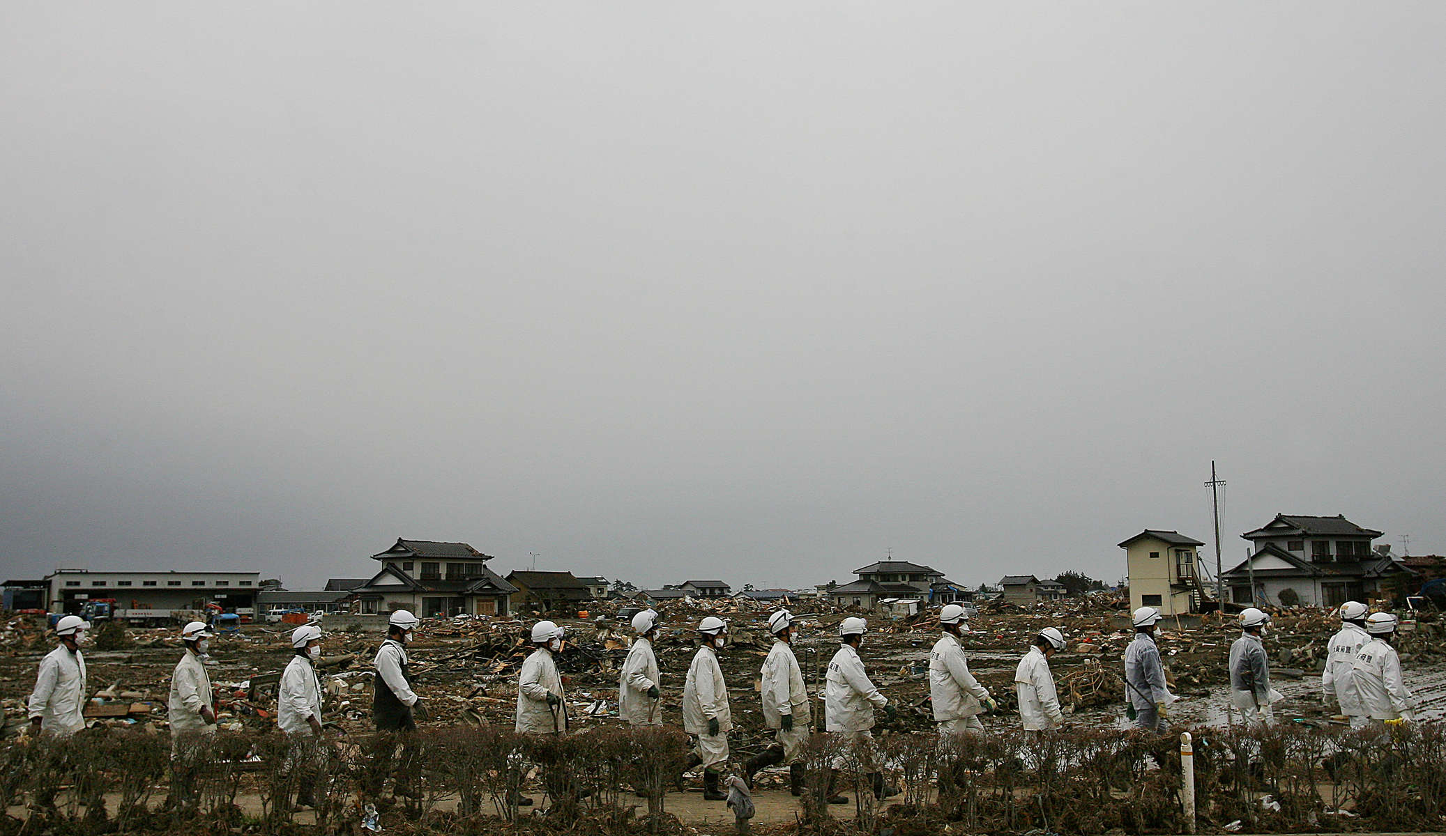 Weeks after the tsunami, police officers continue to search for the missing in Sendai, Japan. (The Press-Enterprise/ Mark Zaleski)
