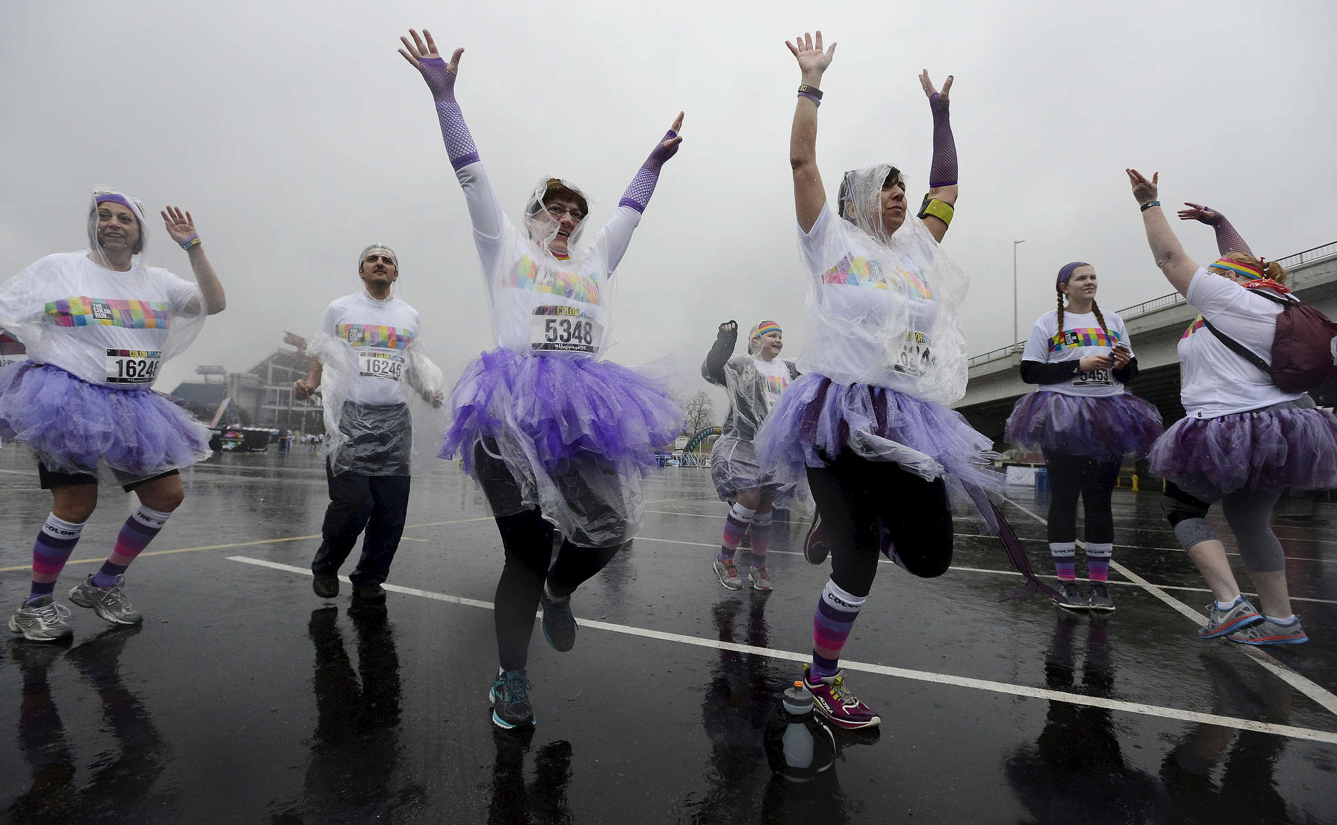 A group of women in tutus warm up in the rain before the 5K Color Run in Nashville, Tenn. (Mark Zaleski/ For The Tennessean)