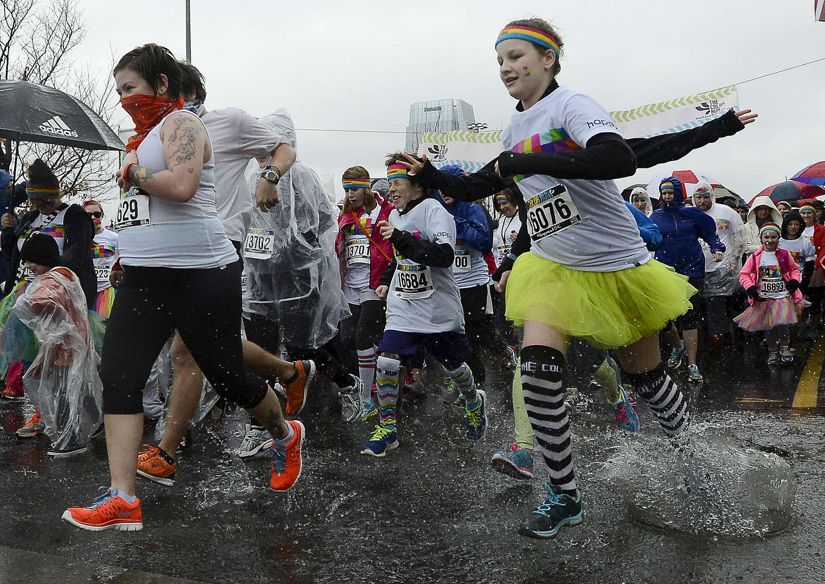 Runners splash through the rain at the start of the 5K Color Run in Nashville, Tenn. (Mark Zaleski/ For The Tennessean)