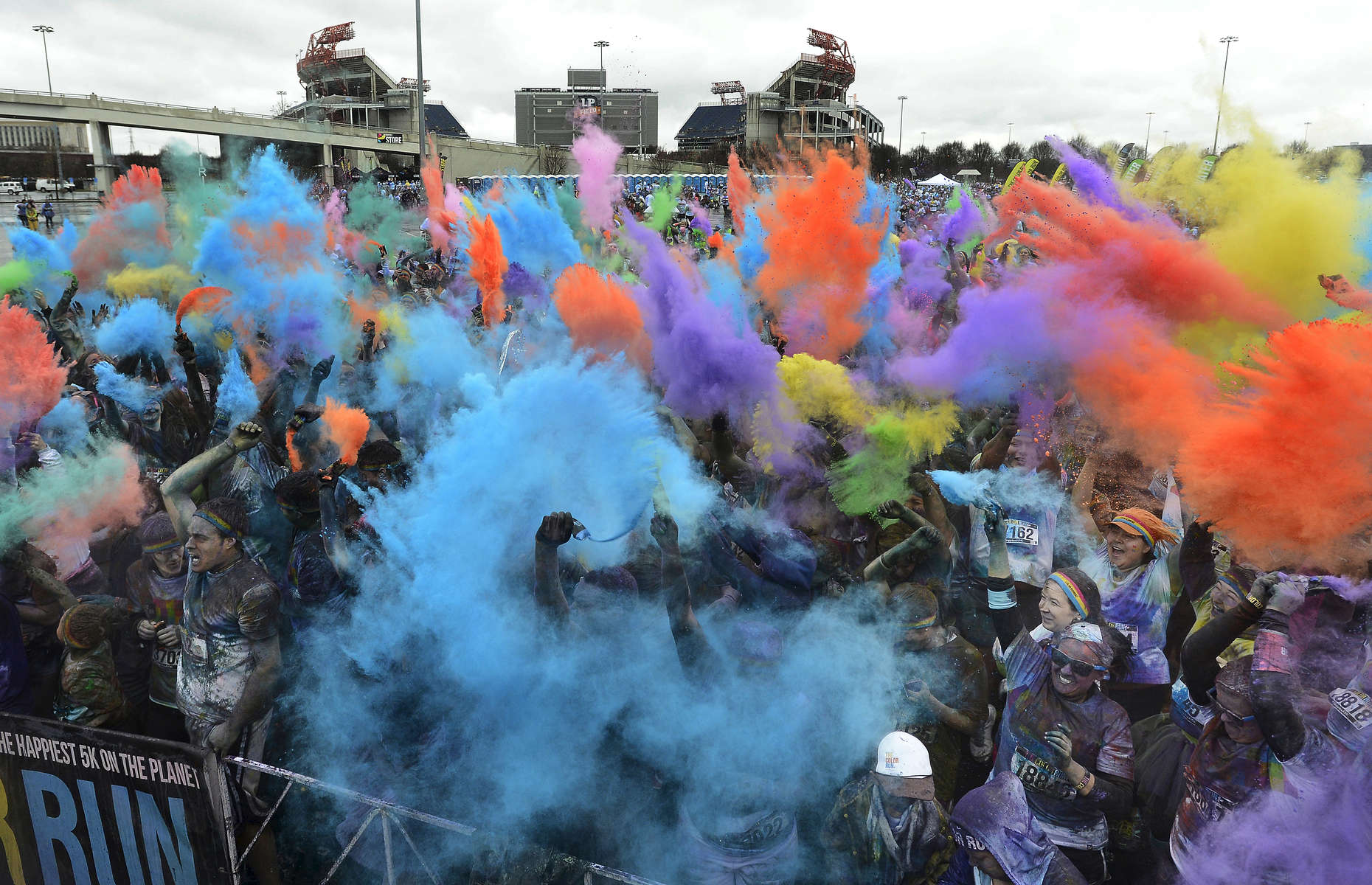 Runners celebrate in the parking lot of LP Field at the end of the Color Run in Nashville, Tenn. (Mark Zaleski/ For The Tennessean)