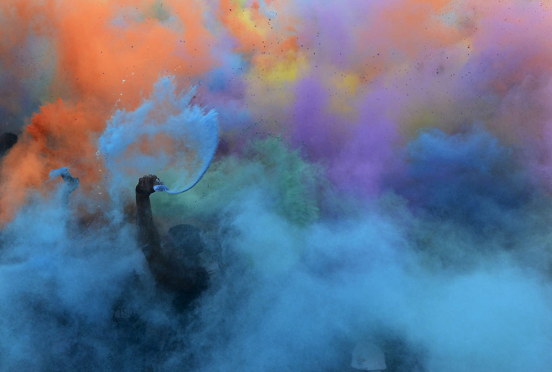 Runners spread colored powder in the air at the end of the Color Run in Nashville, Tenn.(Mark Zaleski/ For The Tennessean)