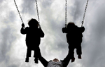 Teri Radcliff leans back and pushes her twin two-year-old boys Calvin, left, and Henry on a swing set while spending the afternoon at Granny White Park in Brentwood, Tenn. (The Tennessean/ Mark Zaleski)
