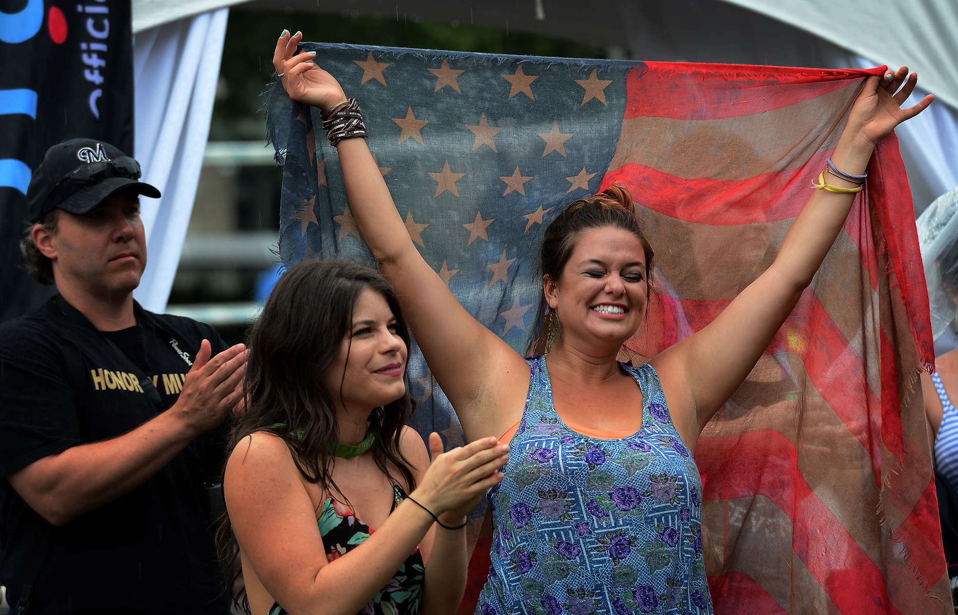 Kada Unwin, center, and Elizabeth Dowgin celebrate while listening to Danielle Peck perform at Transitions Performance Park during the 2013 CMA Music Festival in Nashville, Tenn. (The Tennessean/ Mark Zaleski)