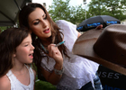 Country music singer Danielle Peck autographs a cowgirl hat for Makayla Anderson, 8, after performing for the crowd at Transitions Performance Park duringthe 2013 CMA Music Festival in Nashville, Tenn. (The Tennessean/ Mark Zaleski)