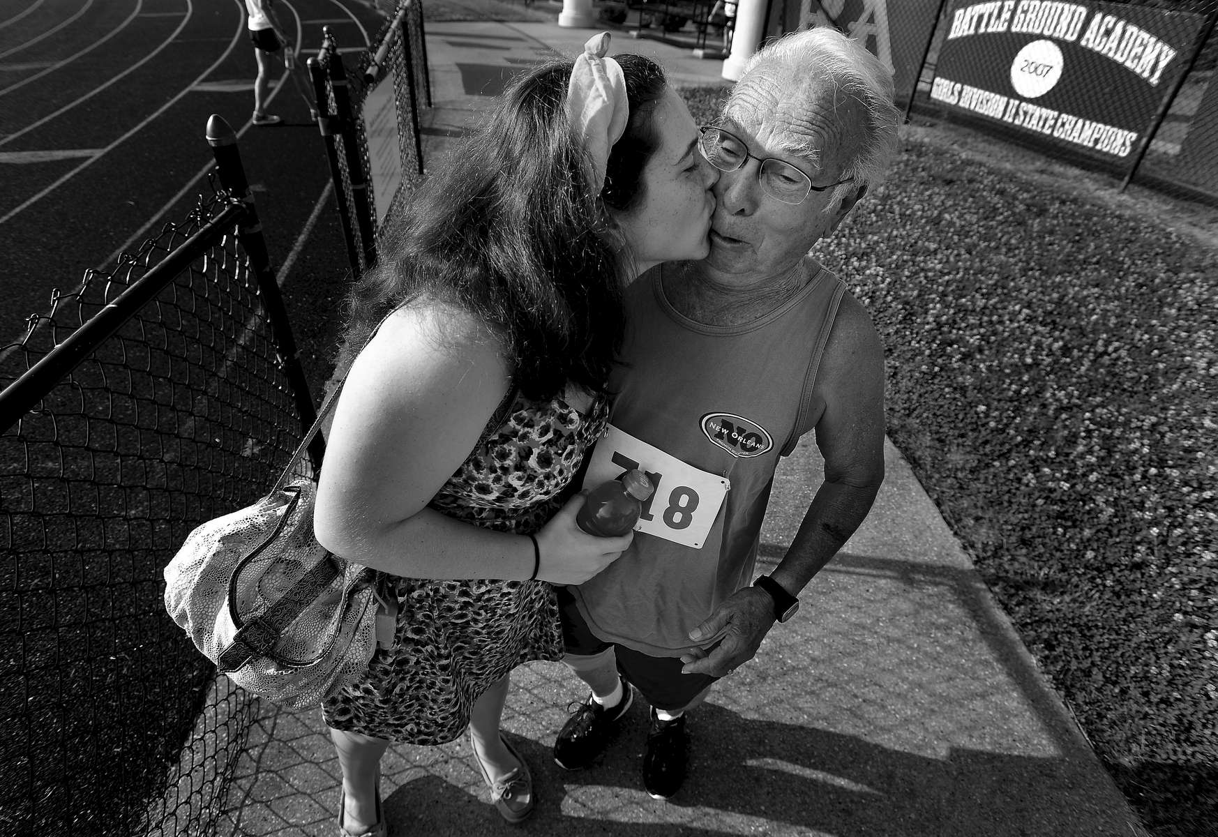 Jewel Trial surprises her great grandfather, Charles Trial, 78, with a kiss before he competed in the men's 400m and 1500m events during the Tennessee Senior Olympics State Finals in Franklin, Tenn. (Mark Zaleski/ The Tennessean)