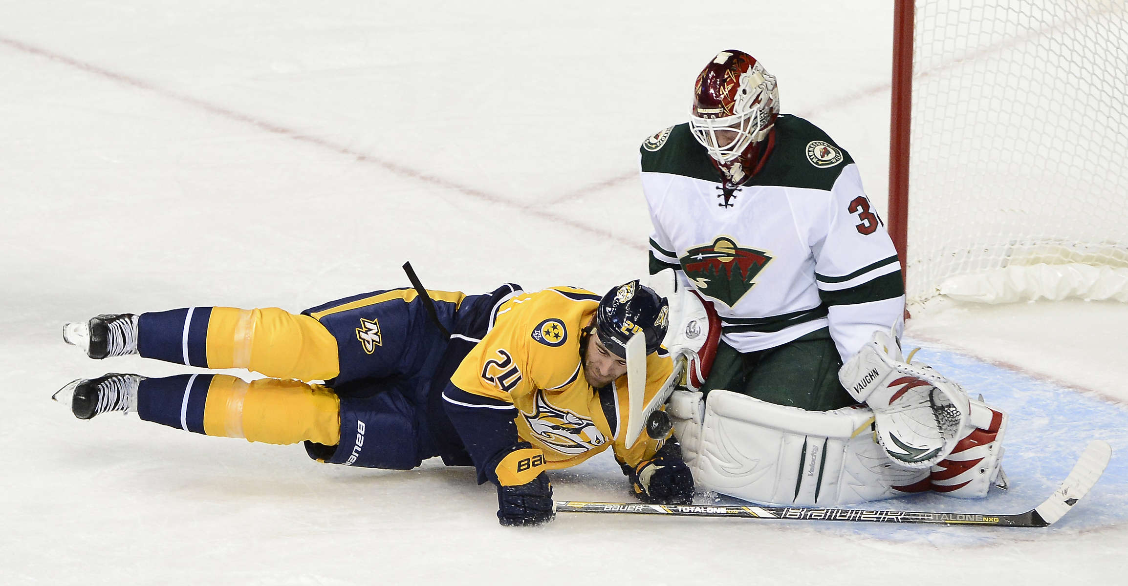 Nashville Predators forward Eric Nystrom collides with Minnesota Wild goalie Niklas Backstrom after being slashed resulting in a penalty shot in the first period of an NHL hockey game on Oct. 8, 2013, in Nashville, Tenn. (The Tennessean/ Mark Zaleski)