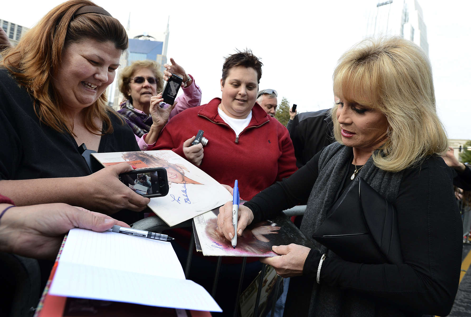 Barbara Mandrell signs autographs for fans after arriving at the ceremony for the 2013 inductions into the Country Music Hall of Fame in Nashville, Tenn. The inductees are Bobby Bare, the late “Cowboy” Jack Clement and Kenny Rogers. (AP Photo/ Mark Zaleski)