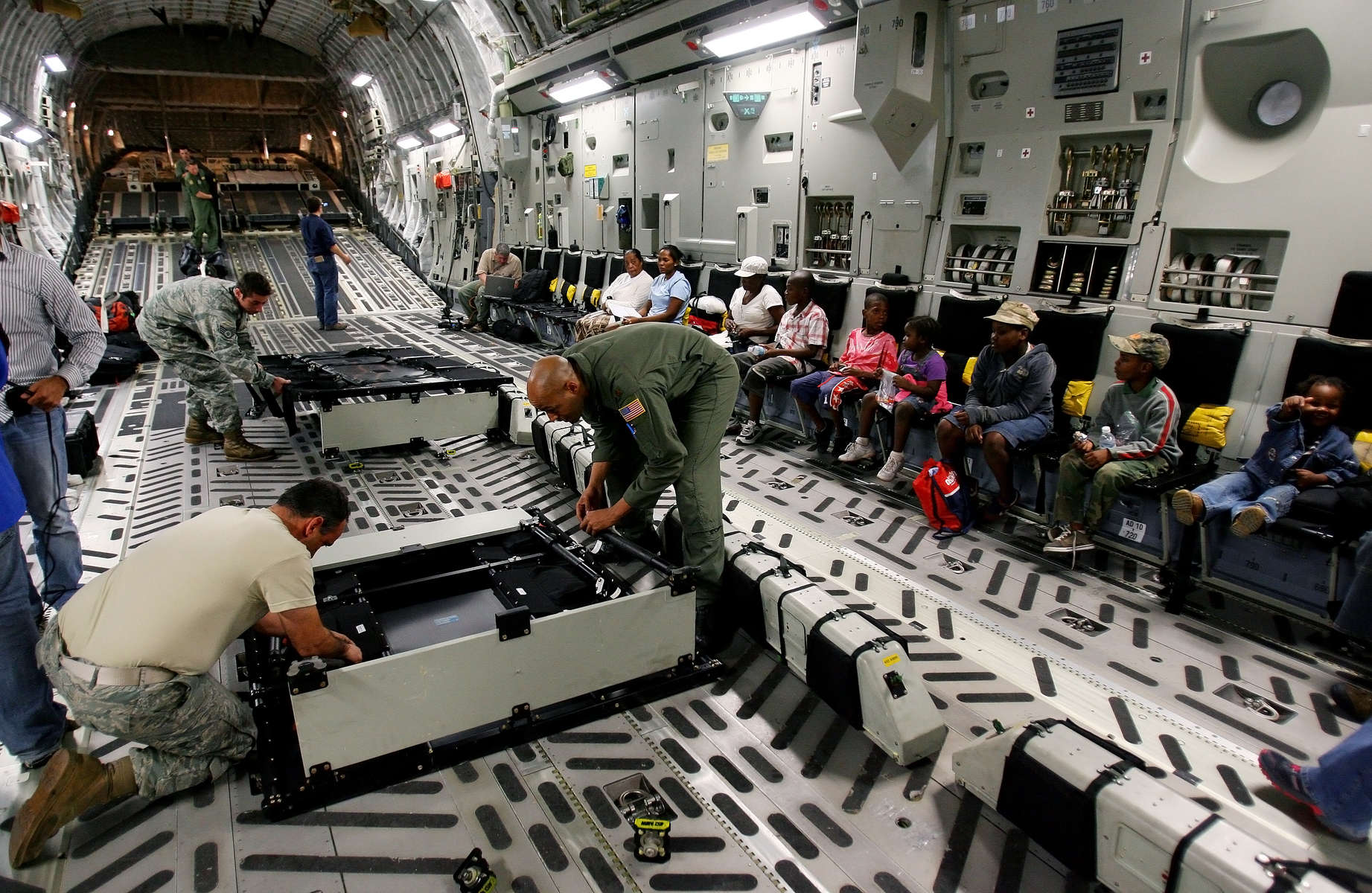 March Air Reserve Base C-17 Master Sgt. Lee Markos, left, and Commander Major Averie Payton put together more seating in the cargo bay of the plane to accommodate seating for 52 children from a orphanage in Port-Au-Prince, Haiti. The children are being evacuated to Orlando, Fla., to meet the families who adopting them. (The Press-Enterprise/ Mark Zaleski)