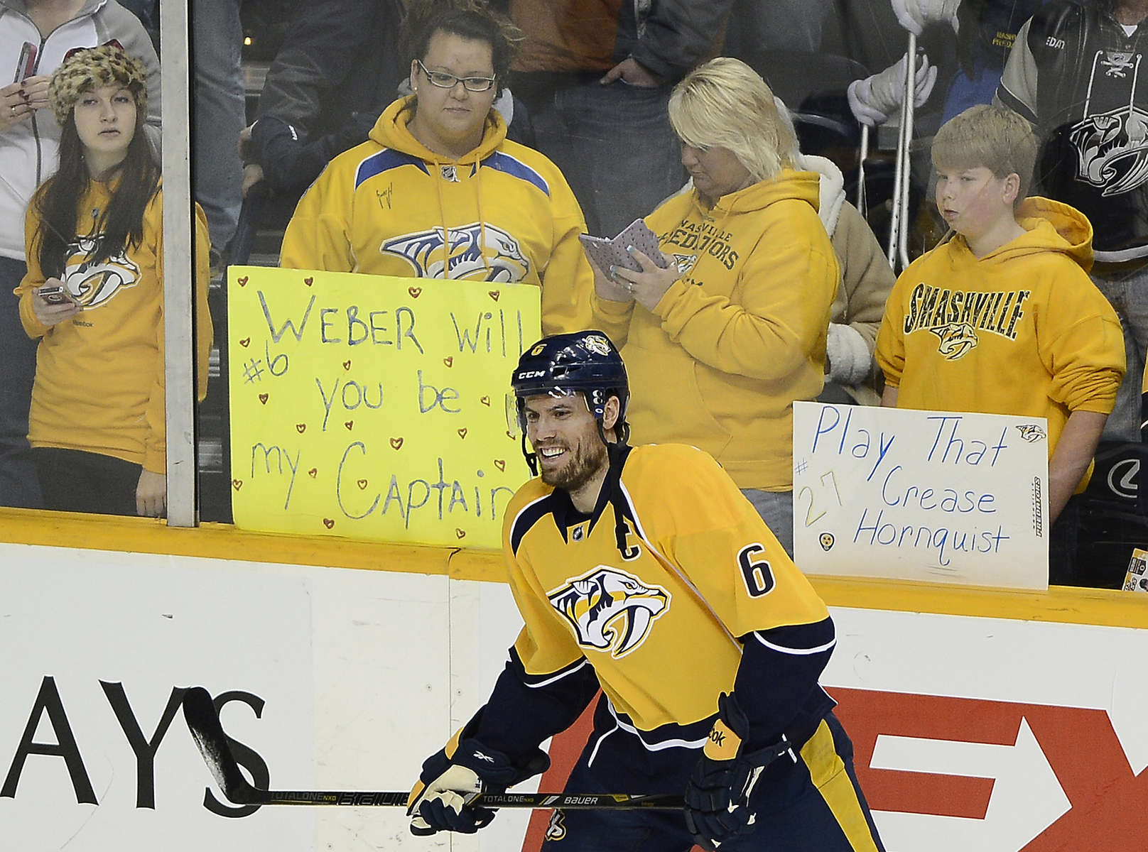 Nashville Predators fans watch defenseman Shea Weber warms up on the ice before playing against the Boston Bruins of an NHL hockey game on Dec. 23, 2013, in Nashville, Tenn. (AP Photo/ Mark Zaleski)