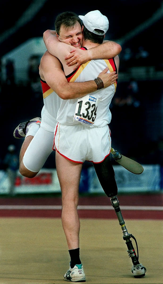 Germany's Roberto Simonazzi, left, is lifted by fellow teammate Horst Beyer after Simonazzi won the gold medal in the men's amputee shot put. His teammate Horst Beyer took the silver medal, giving Germany its first medals in the shot put competition. (The San Bernardino Sun/ Mark Zaleski) 