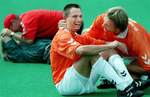Carlo Denerink of the Netherlands, center, celebrates with Rene Glimmerueen, right, after the Netherlands soccer team clinched the gold medal with a victory over Russia. The Russian team, left, console each other. (The San Bernardino Sun / Mark Zaleski)