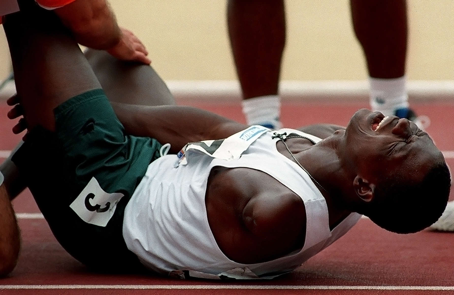 Adeoye Ajibola of Nigeria reacts after pullinghis hamstring muscle in the 100 meter amputee classification race. Ajibola won the gold and a new Paralympic world record in the 100 meter event with the time of 11.13 seconds. (The San Bernardino Sun / Mark Zaleski)