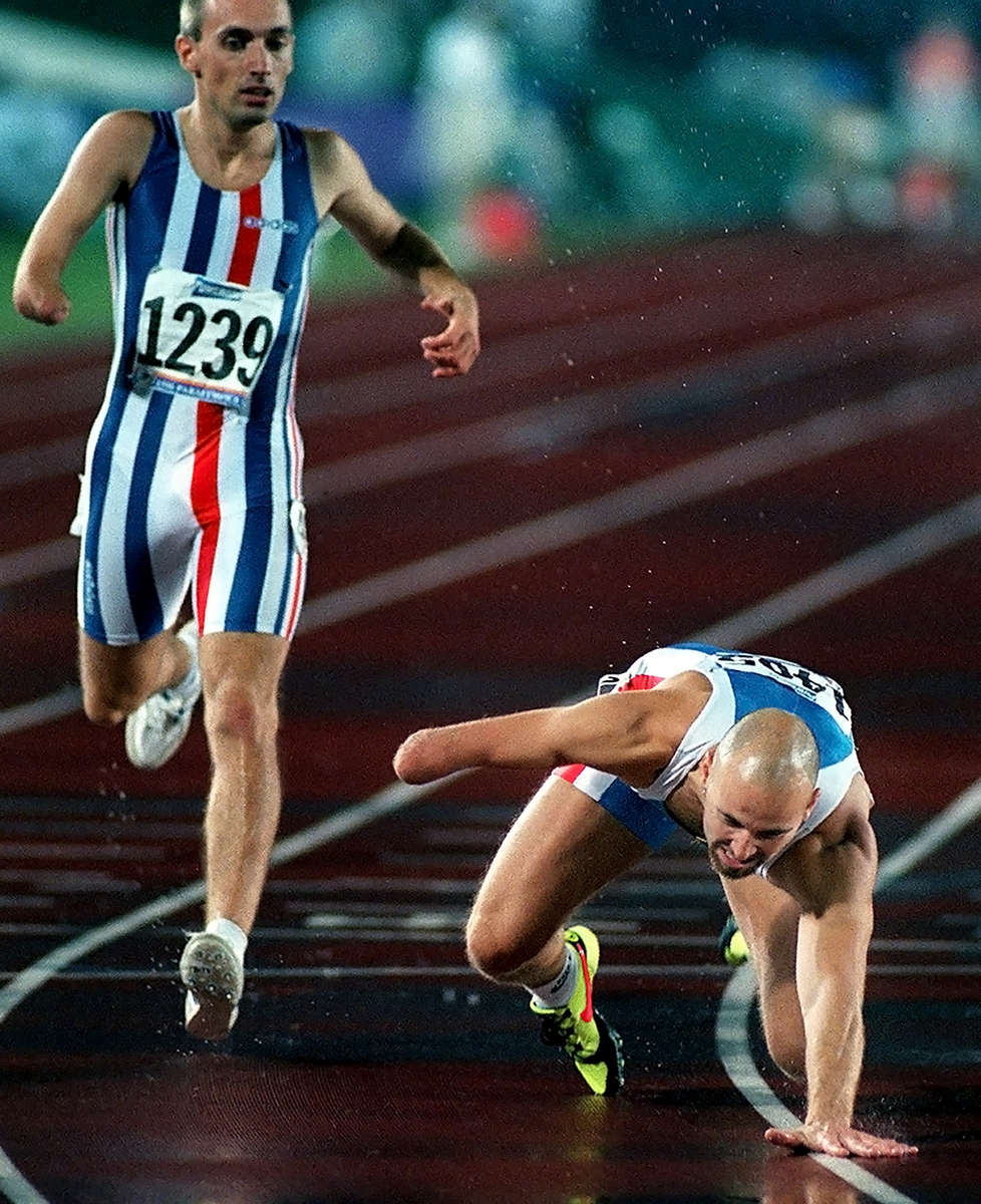 Geir Suerrisson, of Iceland, falls at the finish line of the men's 400m race. Suerrisson finished the race in fifthplace. (The San Bernardino Sun/ Mark Zaleski)