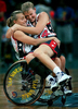 United States women's basketball player Tianna Tozer, right, was lifted by her coach onto the lap of teammate Ronda Jarvis to celebrate their bronze medal victory over Australia in the wheelchair basketball medal round. (The San Bernardino Sun/ Mark Zaleski)