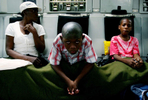 A Haitian boy sits in the cargo bay of a March Air Reserve Base C-17. He was one of 52 children from an orphanage in Port-Au-Prince, Haiti, being evacuated to Orlando, Fla., to meet up with his adopted family. (The Press-Enterprise/ Mark Zaleski)