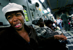 New Jersey resident Guerlyne Louissaint grieves on the flight to Orlando, Fla., because she couldnot get her sister and niece, who are homeless, out of Haiti. The streets are dangerous, she says.(The Press-Enterprise/ Mark Zaleski)