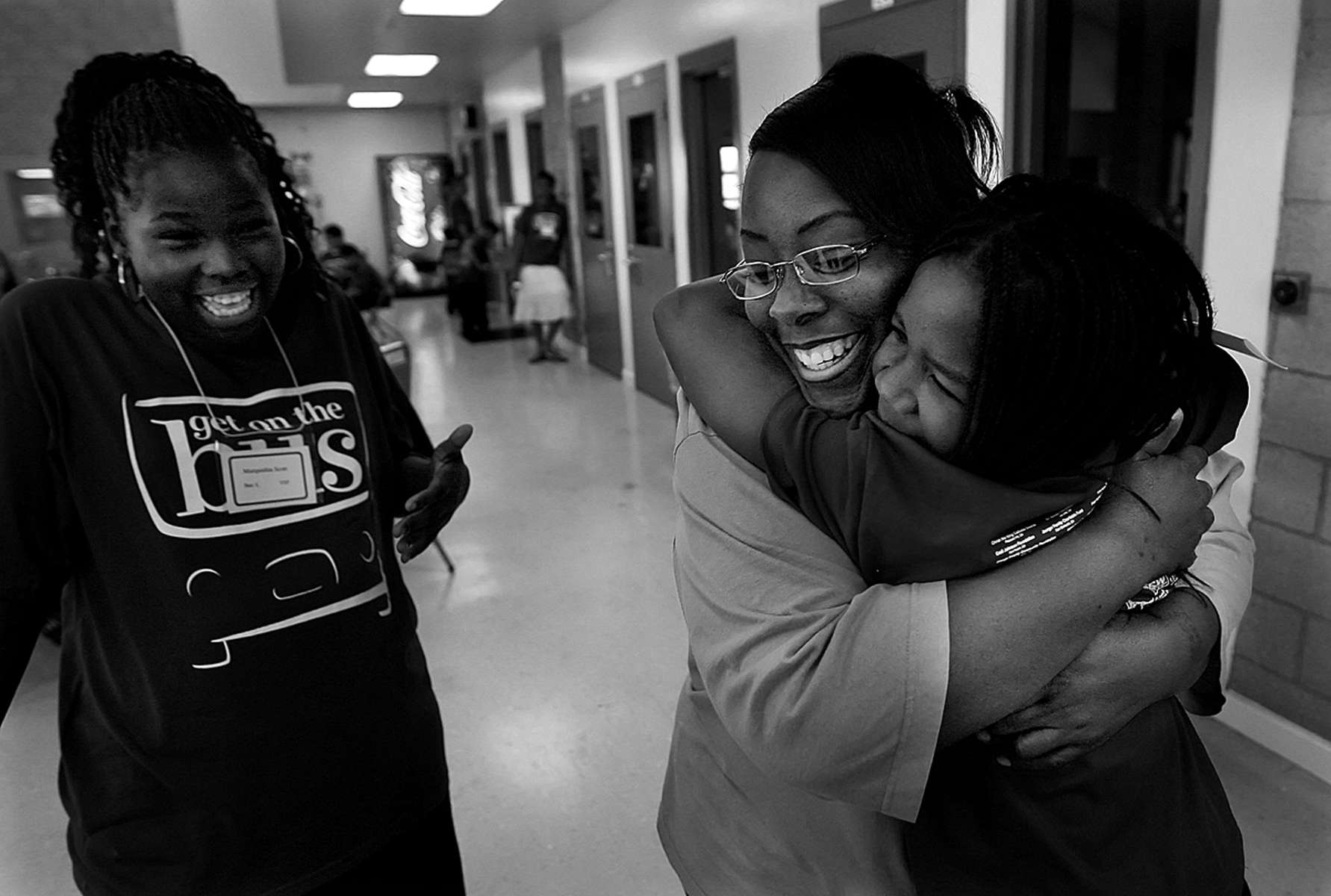Sonja Bullette embraces one of her daughters, Jada Pointer, 9, as her other daughter, Marquisha Scout,laughs with joy. (The Press-Enterprise/ Mark Zaleski)