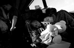 Volunteer Monica McEntee and Jada Pointer fall asleep on the bus on the way home. Sister Sara Shrewsbury, left, also takes a break from the 12-hour day. (The Press-Enterprise/ Mark Zaleski)
