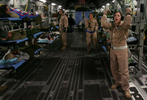 Peterson Air Force Base medical technician Carrie Williamson of Colorado shouts instructions about where to place the next wounded warrior inside a March Air Reserve Base Globemaster C-17 aircraft at Bagram Air Force Base in Afghanistan.The aircraft'scargo area fills with stretchers, wheel chairs and medical equiptment. (The Press-Enterprise/ Mark Zaleski)