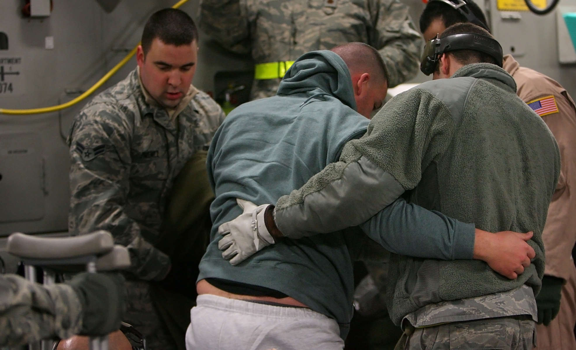 Bagram Air Force Base medical technicians help a wounded warrior get onto a stretcher inside a March Air Reserve Base Globemaster C-17 aircraft at BagramAir Force Base in Afghanistan. The cargo area is transformed into an air hospital for the mission.(The Press-Enterprise/ Mark Zaleski)
