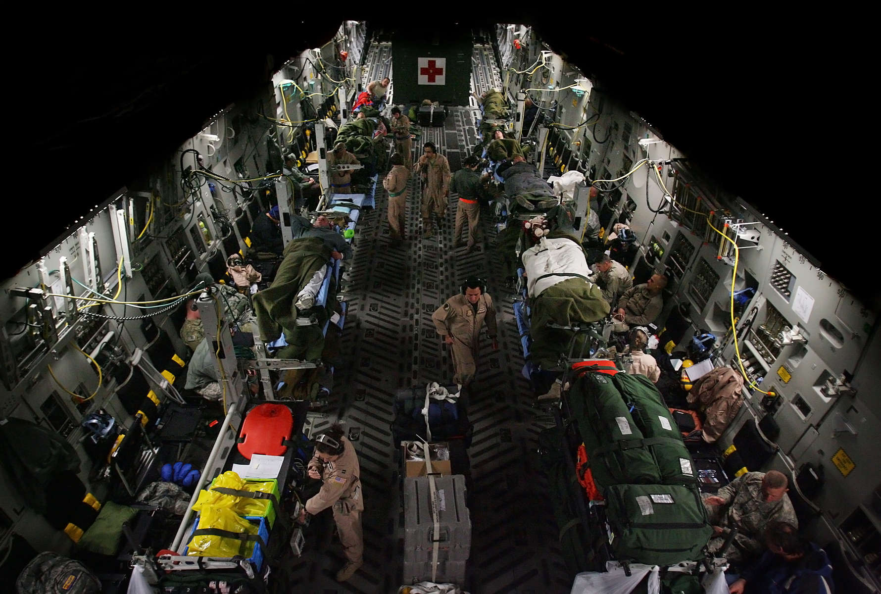 Medical technicians and flight nurses tend to the wounded warriors inside a March Air Reserve Base Globemaster C-17 aircraft after leaving Bagram Air Force Base in Afghanistan. The 30 wounded warriors will be flown to Ramstein Air Force Base in Germany for more medical care.(The Press-Enterprise/ Mark Zaleski)