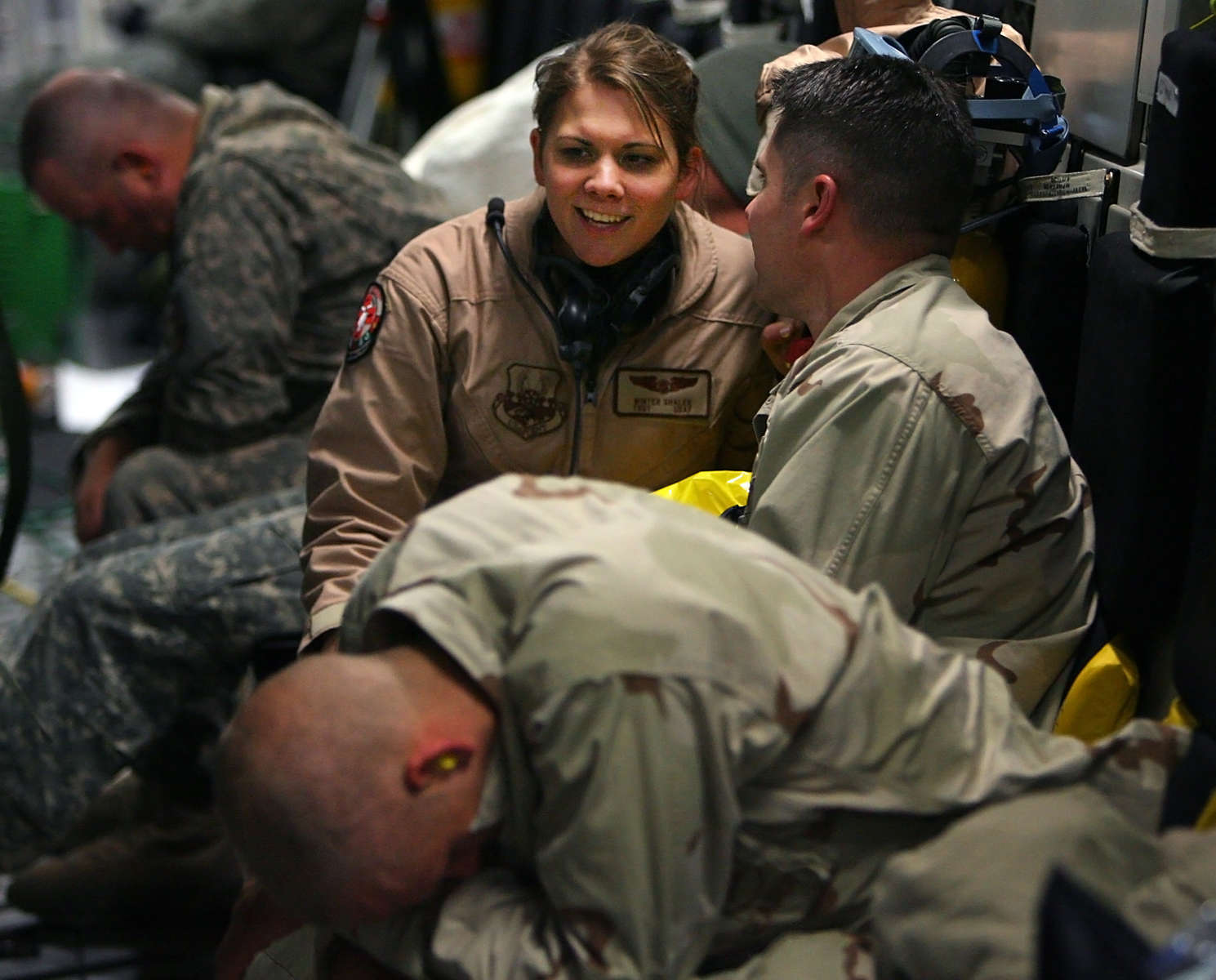 Minneapolis Air Reserve Station medical technician Winter Shaler takes time to talk during the flight with military personnel who were injured in Afghanistanand are being flown to Ramstein Air Force Base in Germany for more medical care. (The Press-Enterprise/ Mark Zaleski)