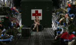 Peterson Air Force Base medical technician Cpt. Carrie Williamson keeps a watchful eye on the wounded while they sleep on a March Air Reserve Base Globemaster C-17 air craftafter leaving Bagram Air Force Base in Afghanistan. (The Press-Enterprise/ Mark Zaleski)