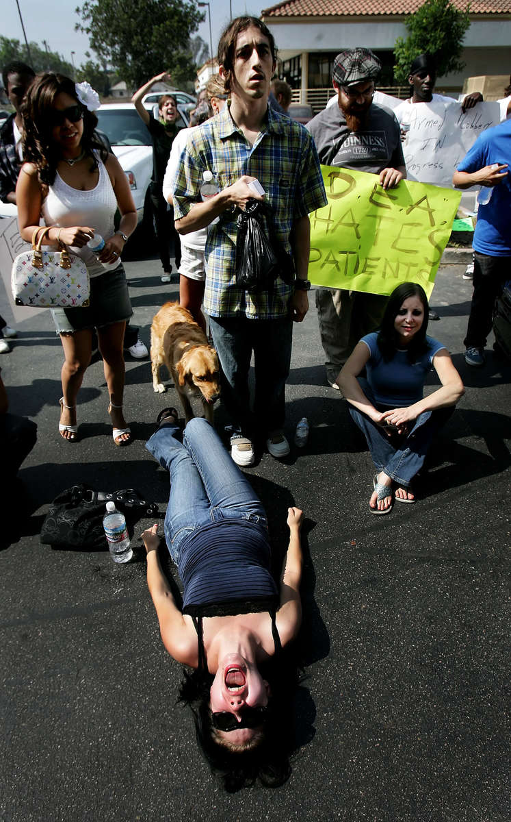 Mayra Godoy, 22, of Colton, Calif., screams while lying on the pavement protesting against DEA agents and police officers who seized medical marijuana and other items from the Healing Nations Collective Medical Marijuana Dispensary in Corona, Calif. (The Press-Enterprise/ Mark Zaleski)
