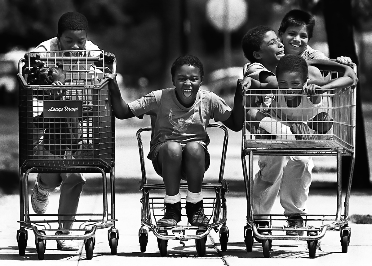 A group of children gathered up several shopping carts to hold a neighborhood race in San Bernardino, Calif. (The San Bernardino Sun/ Mark Zaleski)