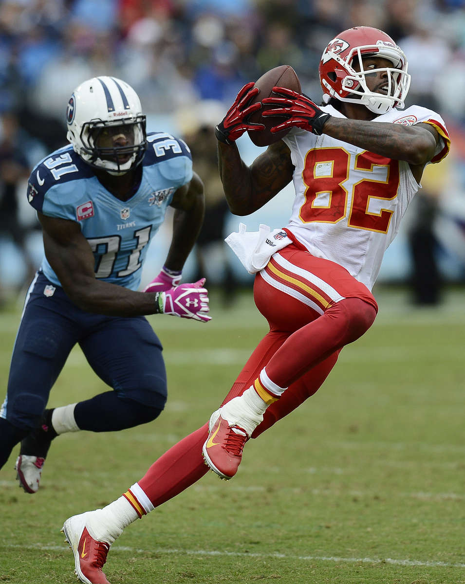 Kansas City Chiefs wide receiver Dwayne Bowe catches a pass as he is defended by Tennessee Titans safety Bernard Pollard in the third quarter of an NFL football game on Oct. 6, 2013, in Nashville, Tenn. (AP Photo/ Mark Zaleski)