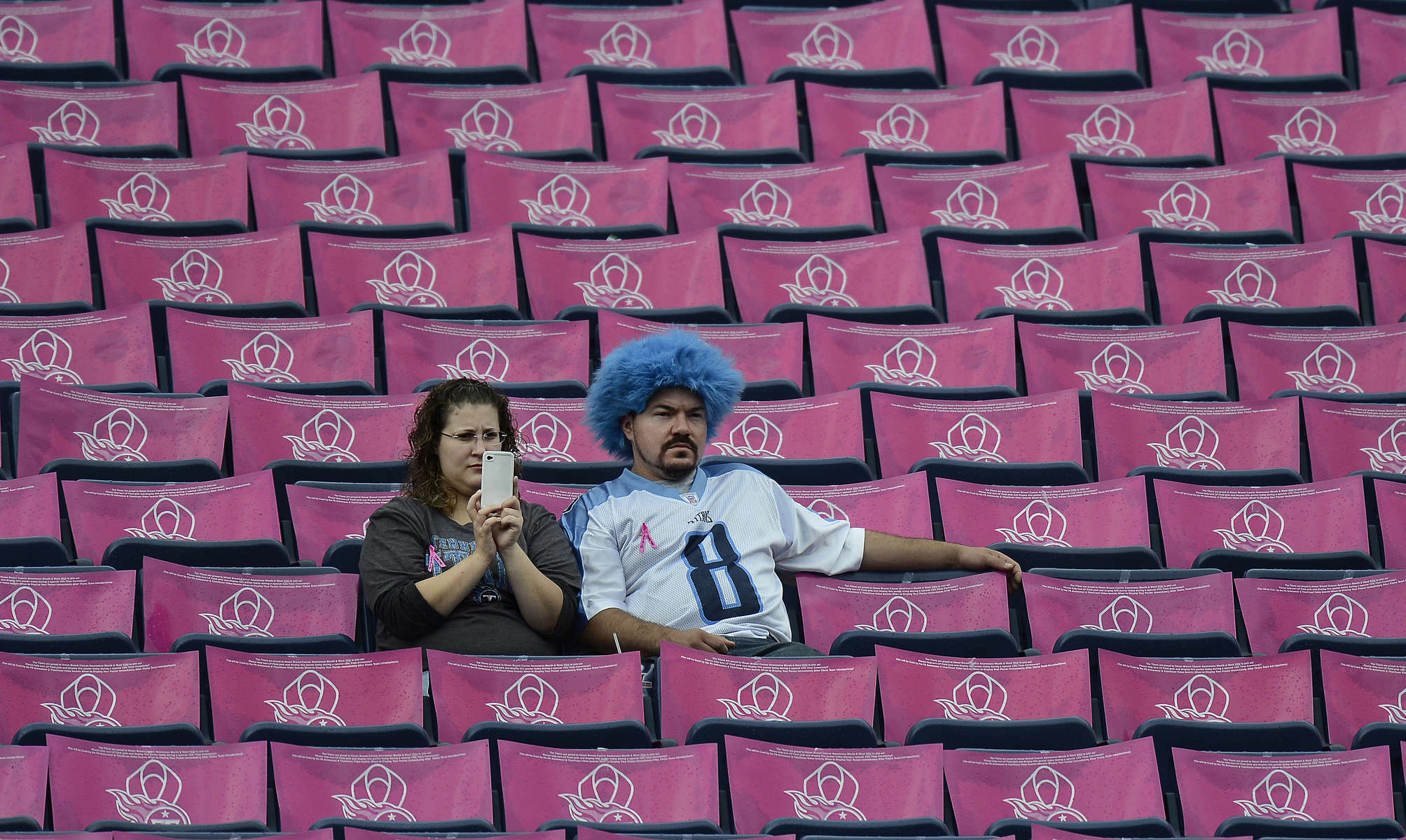 Tennessee Titans fans sit among breast cancer awareness posters before an NFL football game between the Titans and the Kansas City Chiefs on Oct. 6, 2013, in Nashville, Tenn. (AP Photo/ Mark Zaleski)
