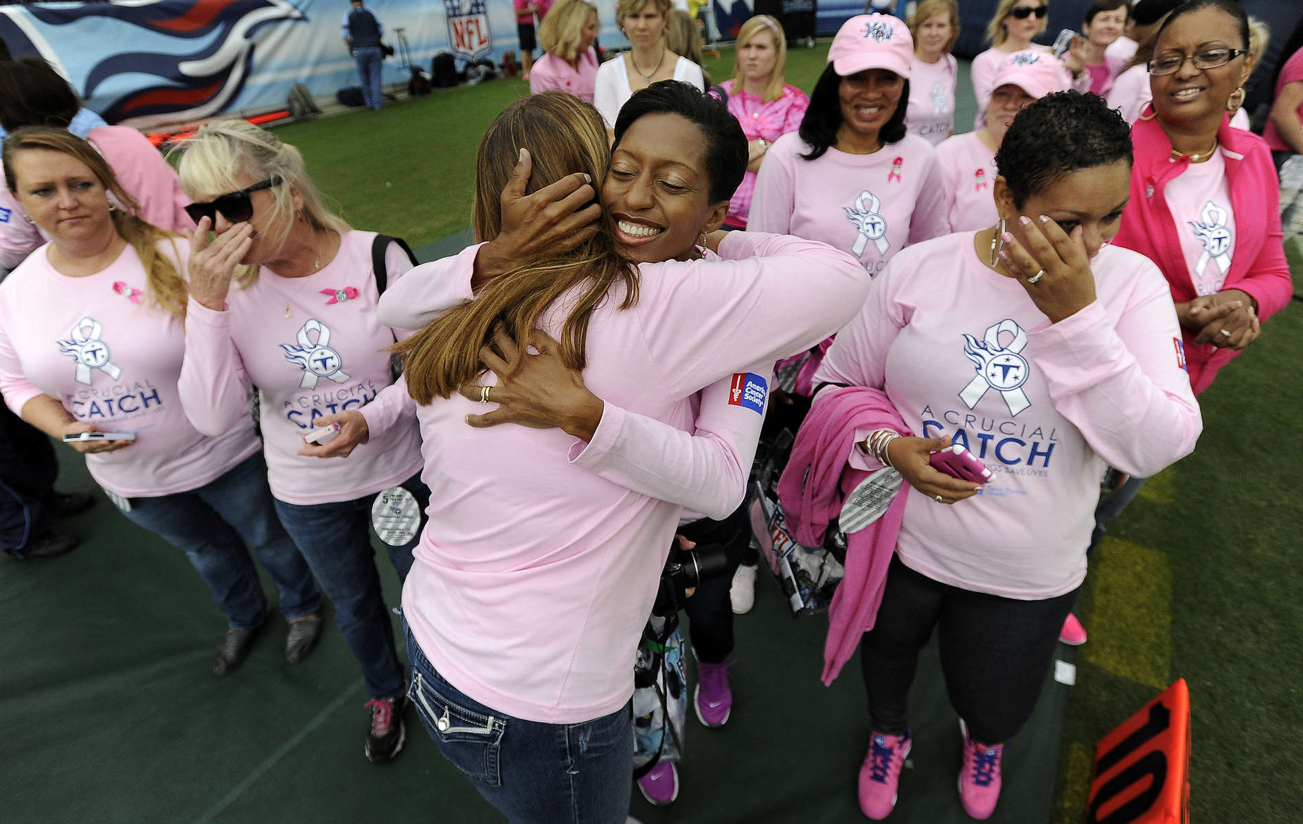 Breast cancer survivors are honored during a breast cancer awareness ceremony before an NFL football game between the Tennessee Titans and the KansasCity Chiefs on Oct. 6, 2013, in Nashville, Tenn. (AP Photo/ Mark Zaleski)