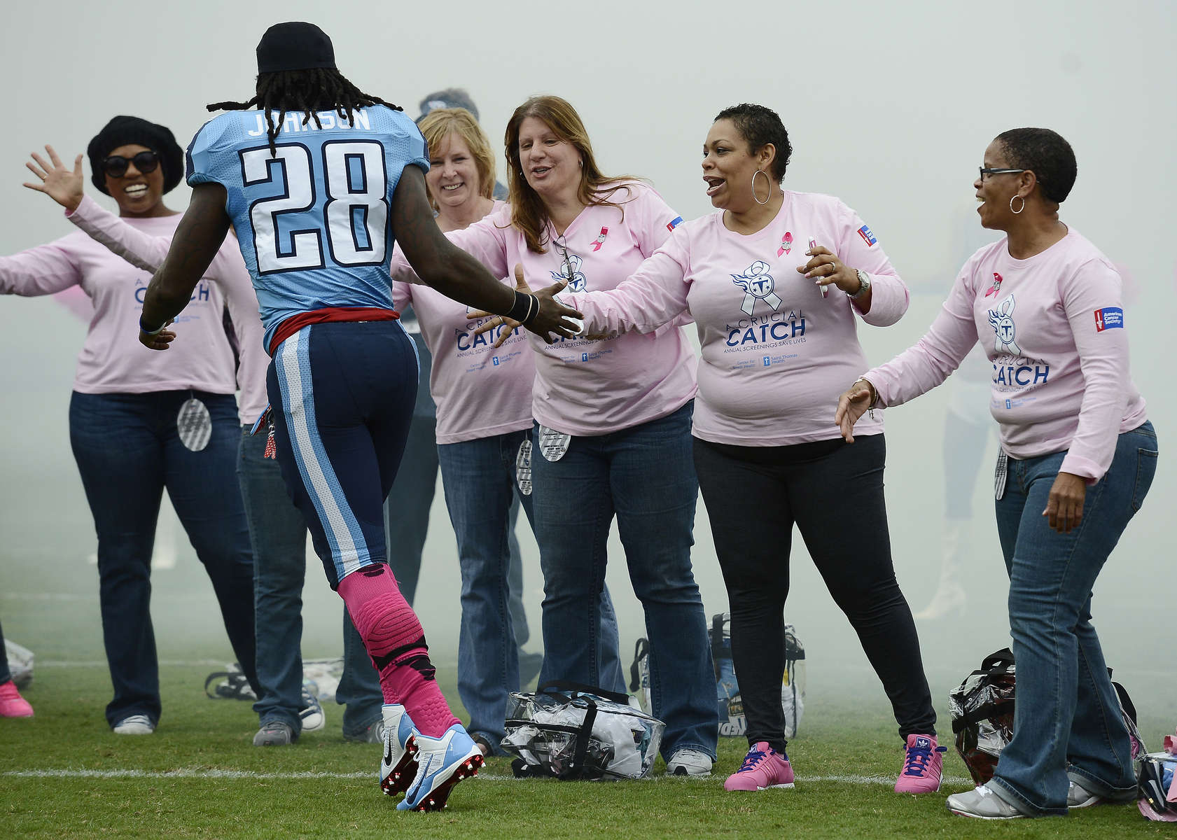 Tennessee Titans running back Chris Johnson slaps hands with breast cancer survivors as heis introduced before an NFL football game between the Titans andthe Kansas City Chiefs on Oct. 6, 2013, in Nashville, Tenn. (AP Photo/ Mark Zaleski)